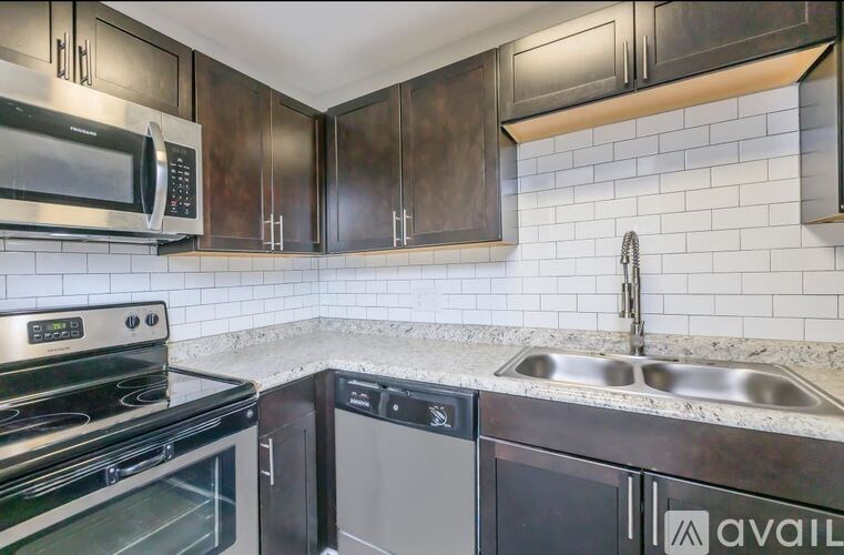 A kitchen with a stove, microwave, and dishwasher.