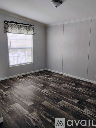 A room with a window and Avail logo on the floor.