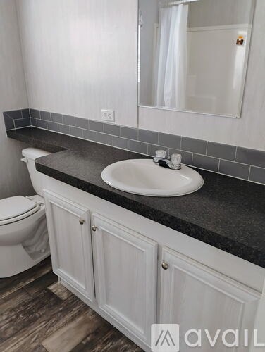 A bathroom with a white toilet and a white sink.