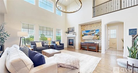 A living room with a white couch and a large window.