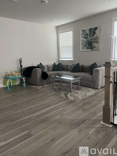 A living room with a grey couch and a coffee table.