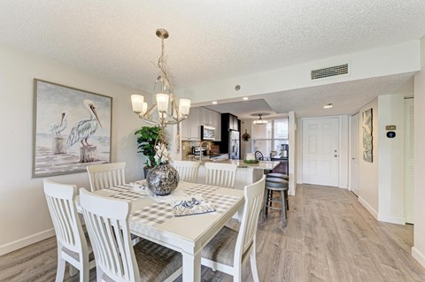 A dining room with a white table and chairs.