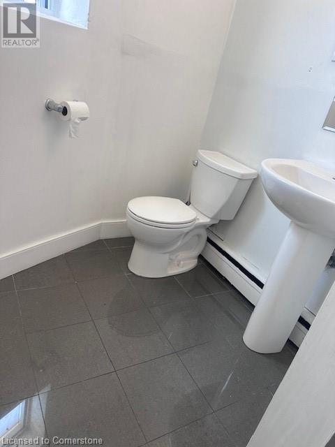 A white toilet and sink in a bathroom.