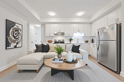 A modern kitchen with a large island and a refrigerator.