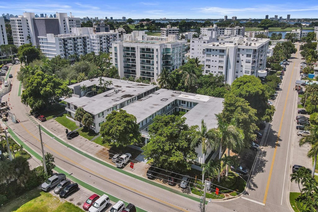A view of a city street with cars and buildings.