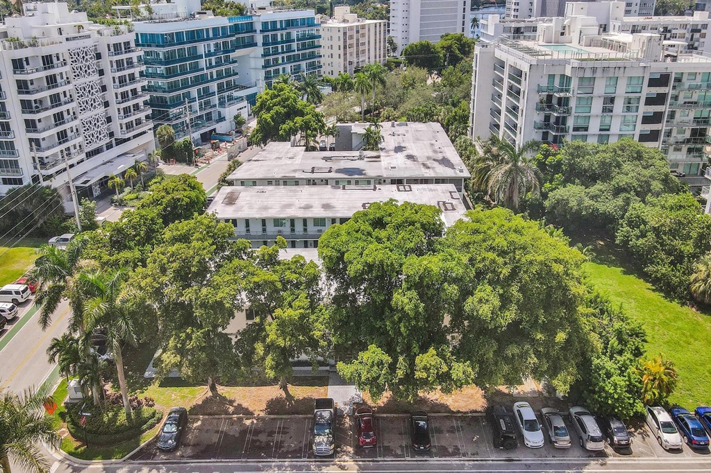A parking lot with cars and a building in the background.