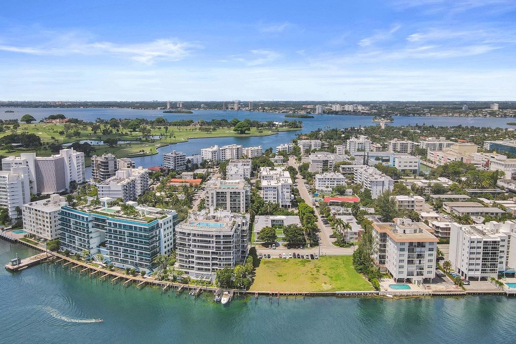 A cityscape with buildings and a body of water.