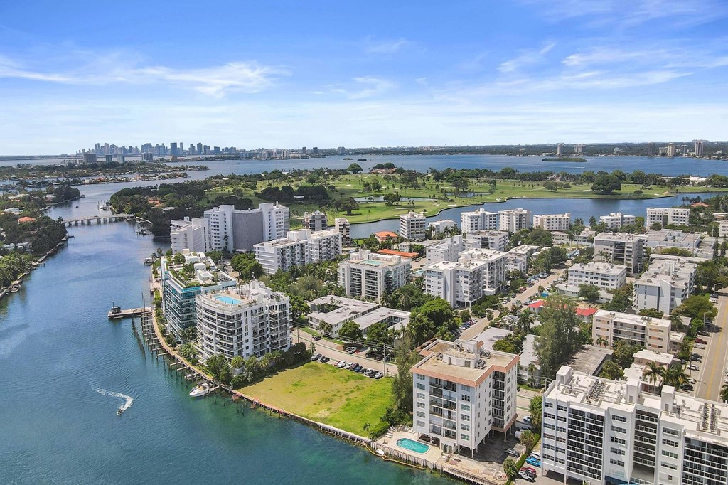 A cityscape with buildings and a body of water.