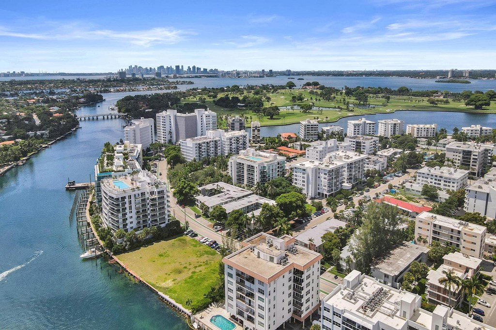 A cityscape with buildings and a body of water.