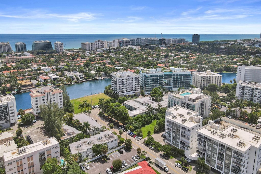A cityscape with buildings, roads, and a body of water.