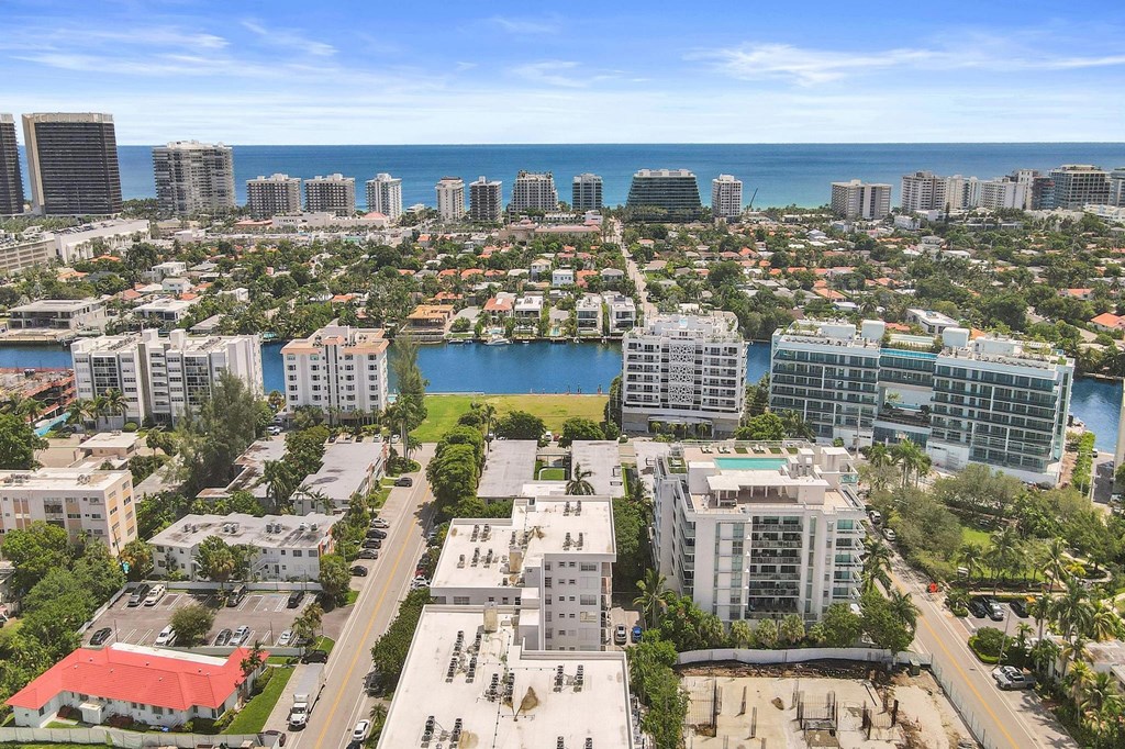 A cityscape with buildings, roads, and a body of water.