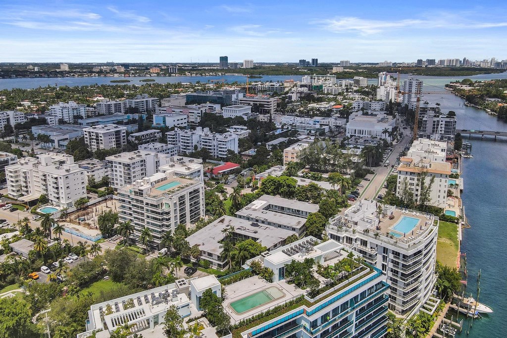 A cityscape with buildings and a body of water.