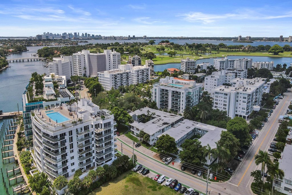 A cityscape with buildings, a road, and a body of water.