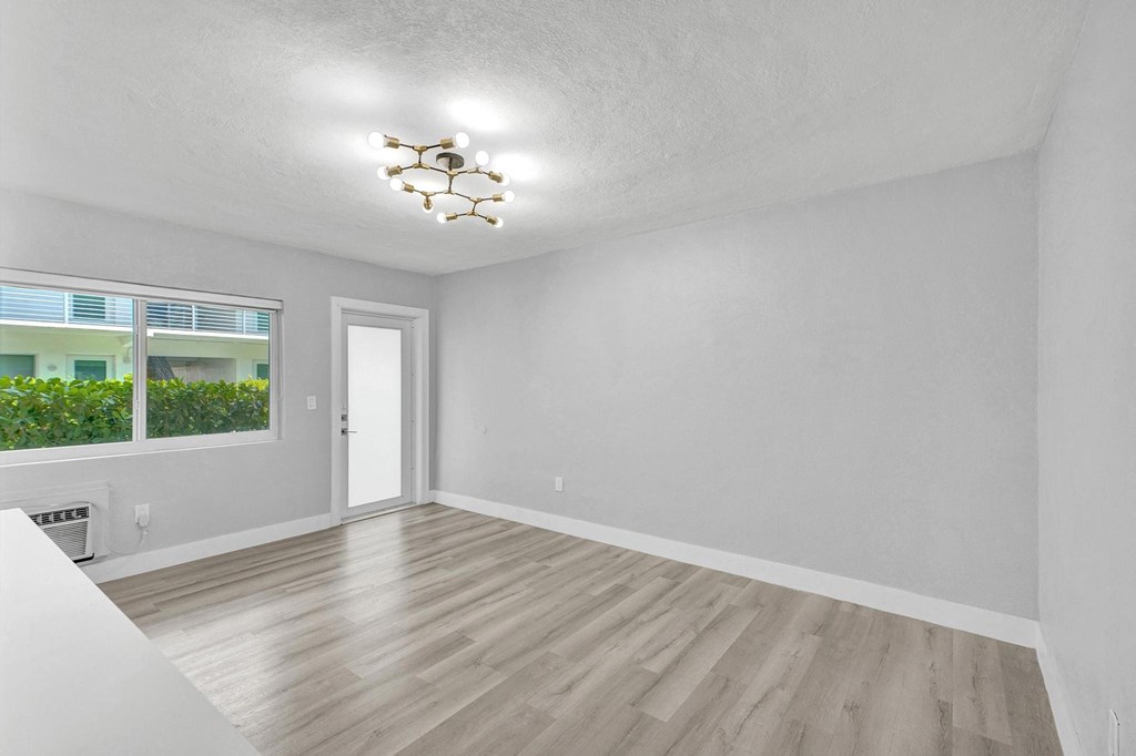 A room with a wooden floor and a ceiling fan.