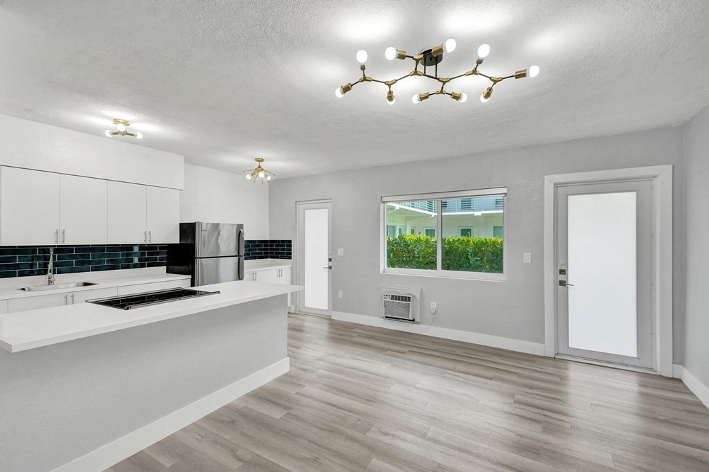 A modern kitchen with white cabinets and a large island.
