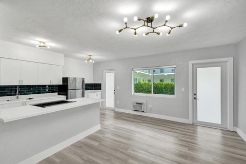 A modern kitchen with white cabinets and a large island.
