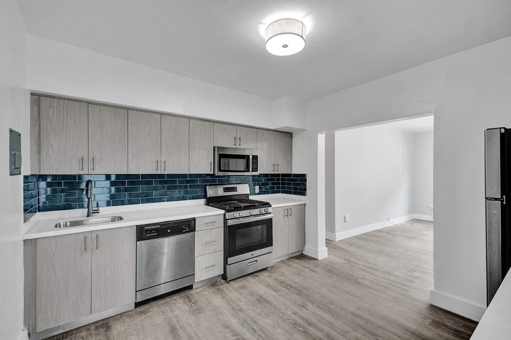 A kitchen with a stove top oven and a microwave.