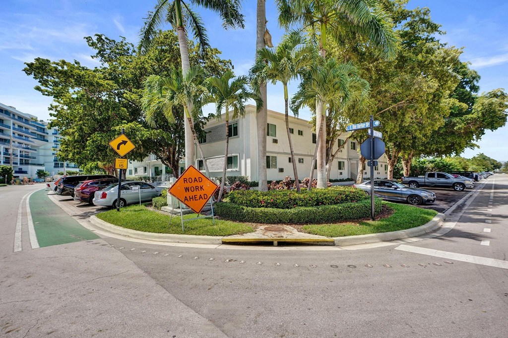 A road work sign is placed on the side of a road.
