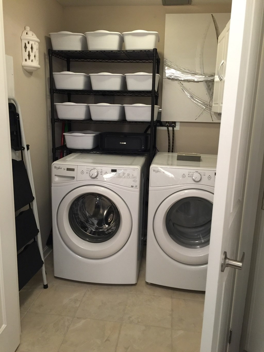 Two front loading washing machines in a small laundry room.