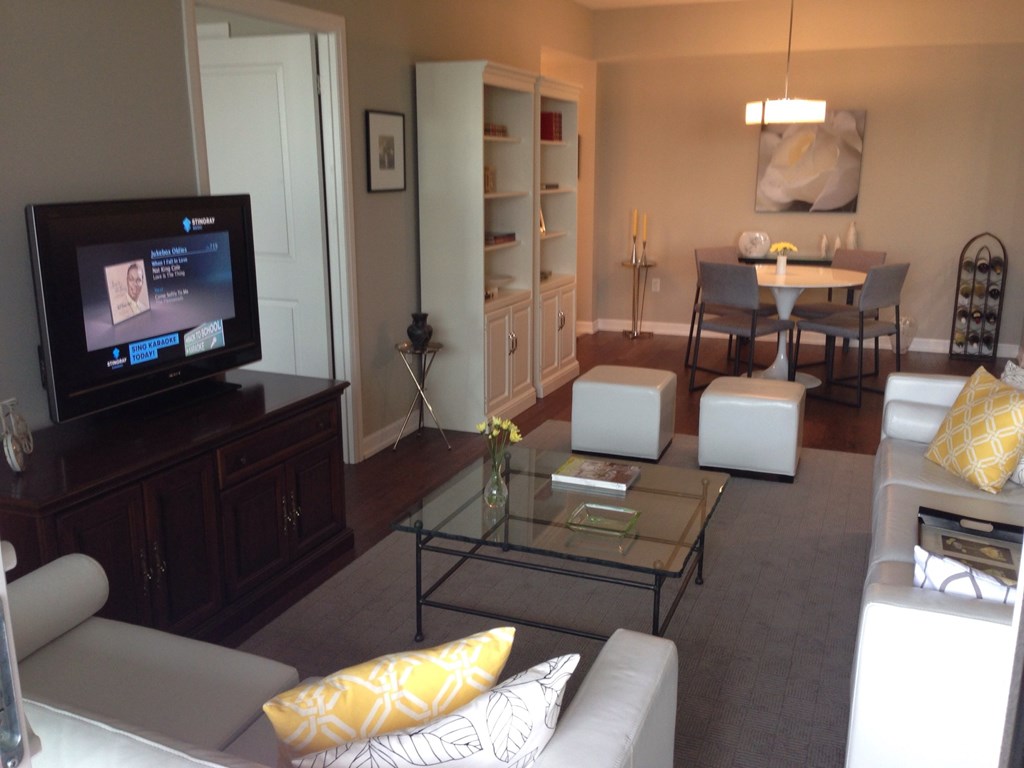 A living room with a television, couch, and coffee table.