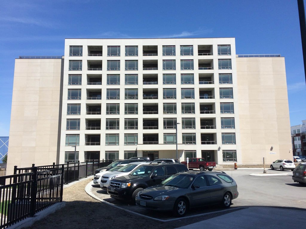 A large building with a parking lot in front of it.