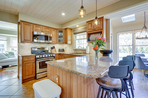 A kitchen with wooden cabinets and a granite countertop.
