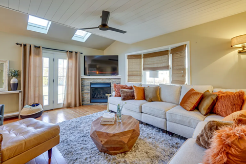 A living room with a fireplace and a television.