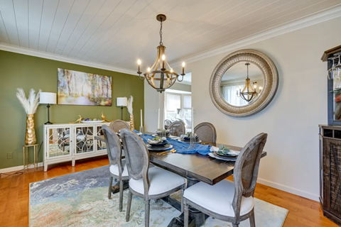 A dining room with a table set for four.