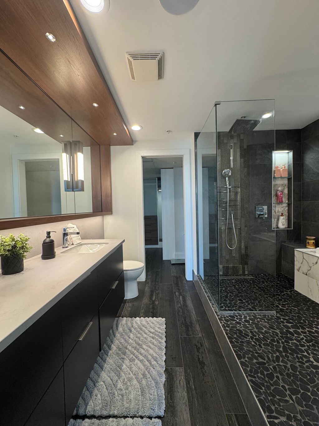 A bathroom with a sink, toilet, and shower.