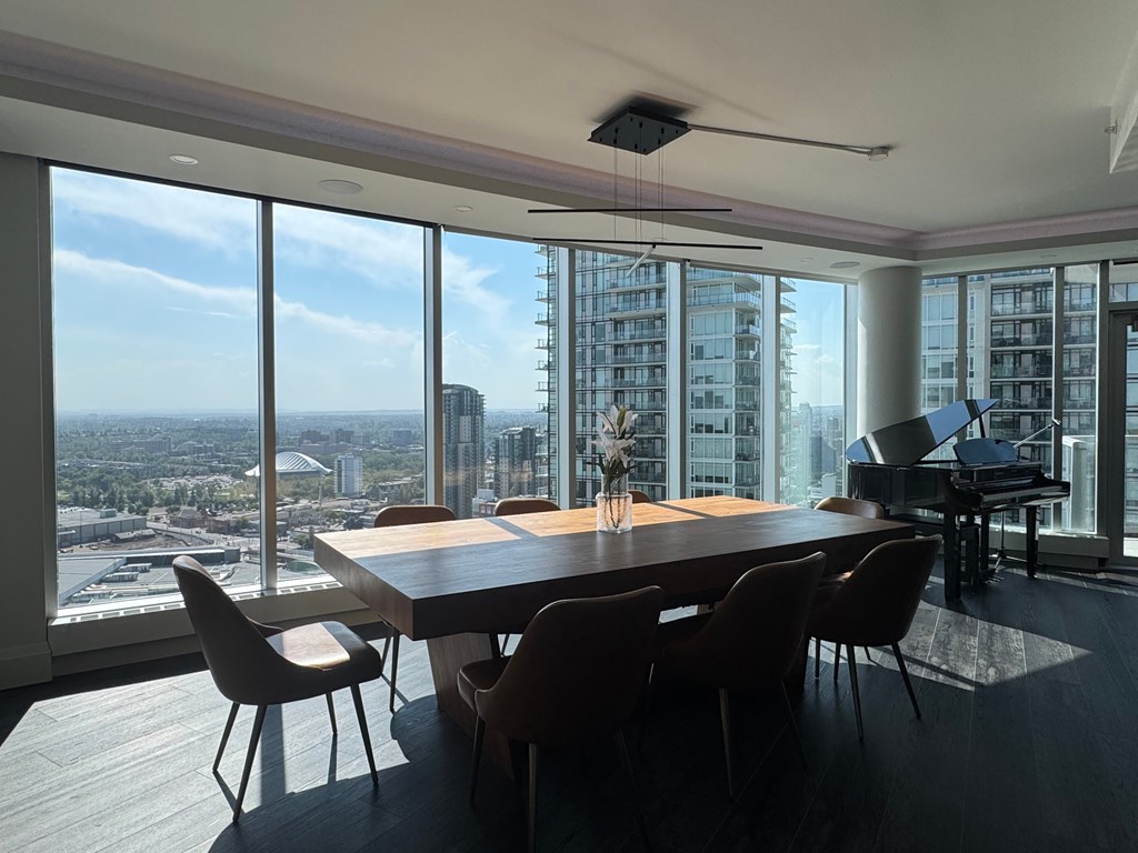 A conference room with a long table and chairs with a view of the city.
