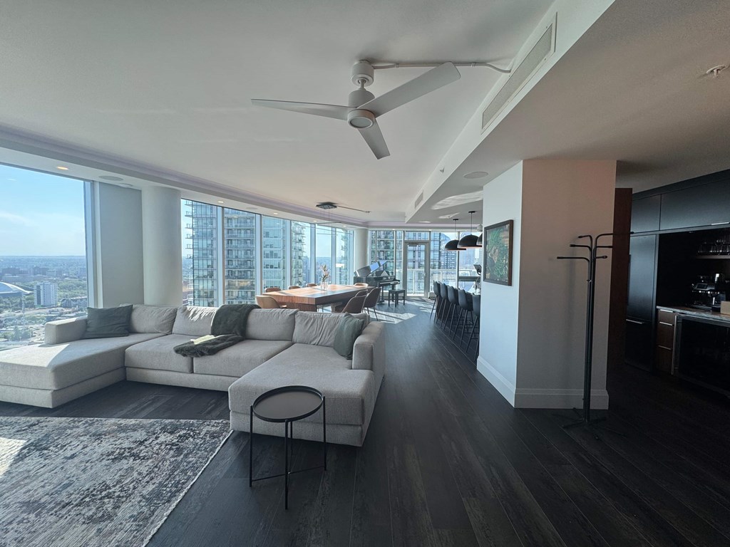 A modern living room with a large window overlooking the city.