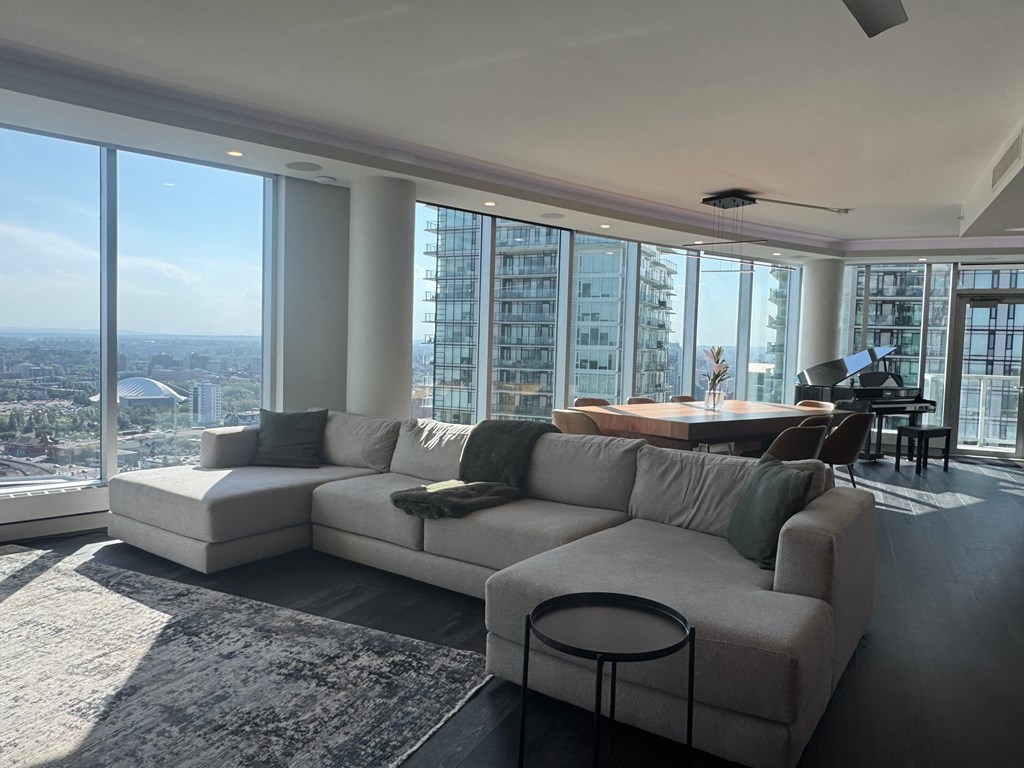 A modern living room with a large window overlooking the city.