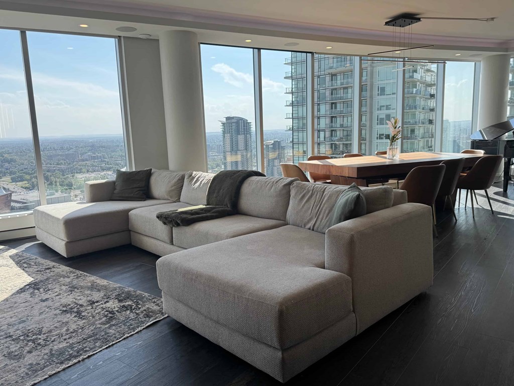 A modern living room with a large window overlooking the city.