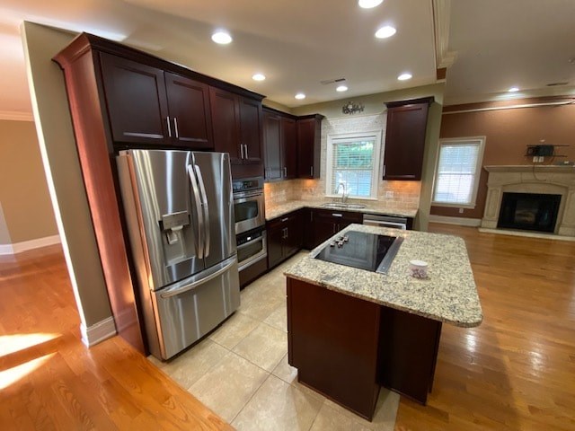 A kitchen with a granite countertop and stainless steel appliances.