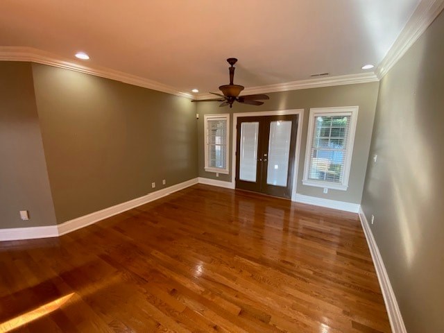 A room with wooden floors and a ceiling fan.