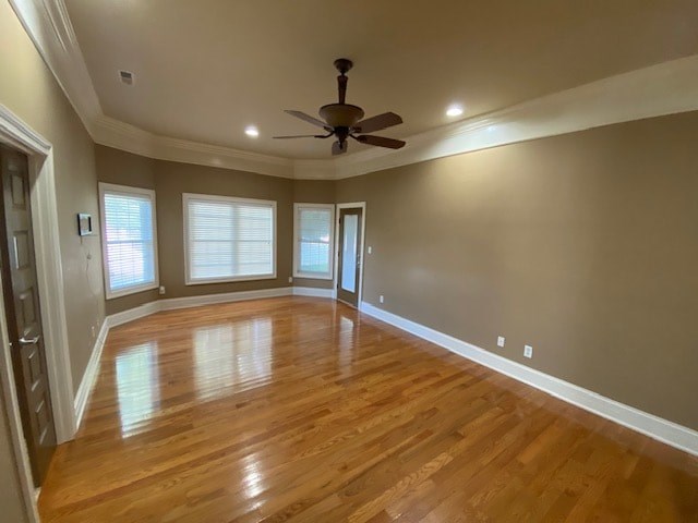 A room with wooden floors and a ceiling fan.