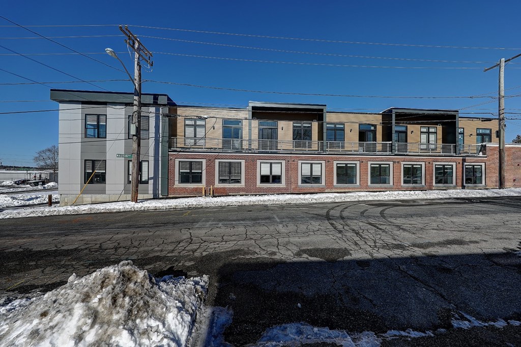 A row of multi-story buildings with a clear blue sky above.