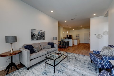 A living room with a grey couch and a coffee table.