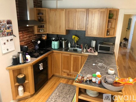 A kitchen with wooden cabinets and a black stove top.