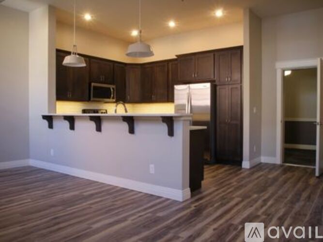 A kitchen with brown cabinets and a white counter.
