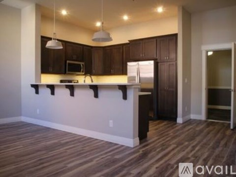 A kitchen with brown cabinets and a white counter.