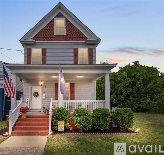A house with a red roof and a flag on the porch.