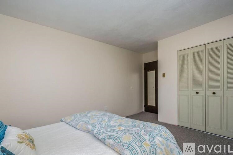 A bedroom with a bed and a wardrobe.