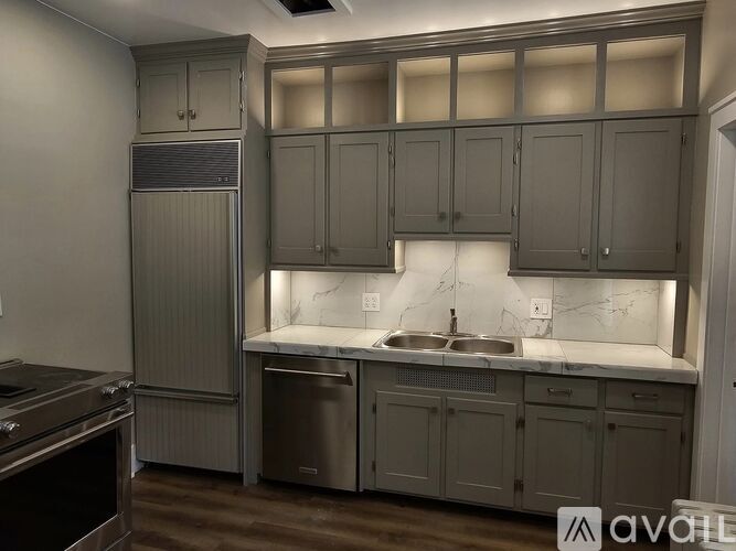 A kitchen with a sink and cabinets.