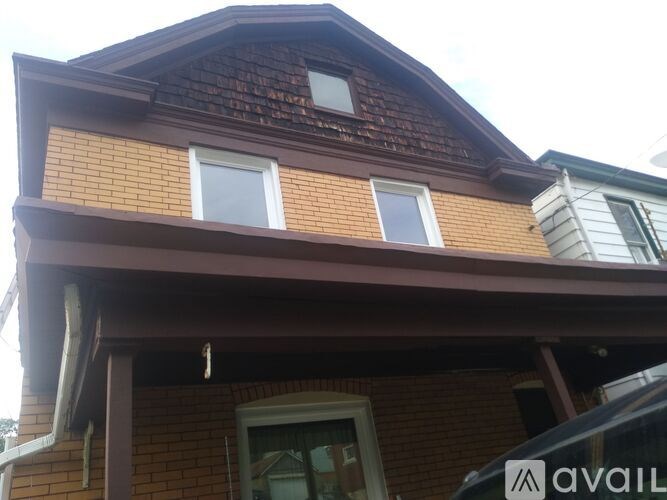 A house with a brown roof and a white window.
