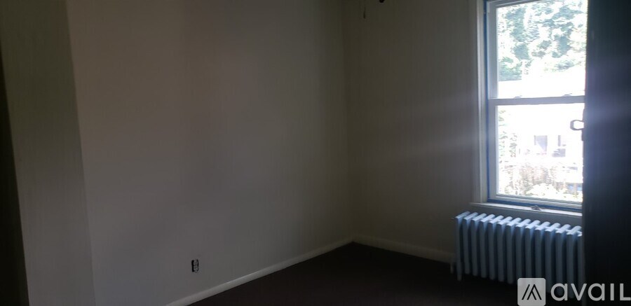 A room with a window and a radiator.