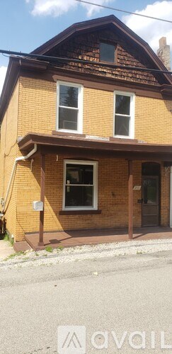 A house with a brown roof and a white window.