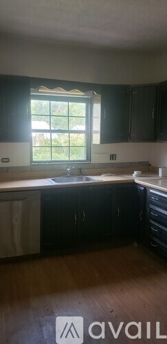A kitchen with a window and a countertop.