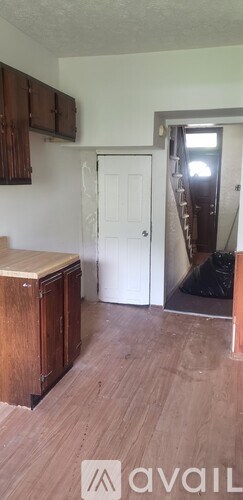 A room with wooden floors and a white door.
