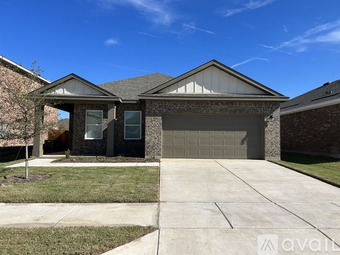 A house with a garage and a driveway is for sale.